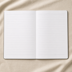 An open lined notebook or journal laid flat on a beige fabric background.